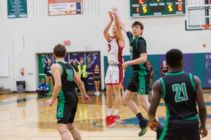 Glenbard East's Danny Snyder shoots a jumper over York's Joseph Lubbe at the Class 4A Bartlett Sectional Final on Friday, March 6,2026 in Bartlett.