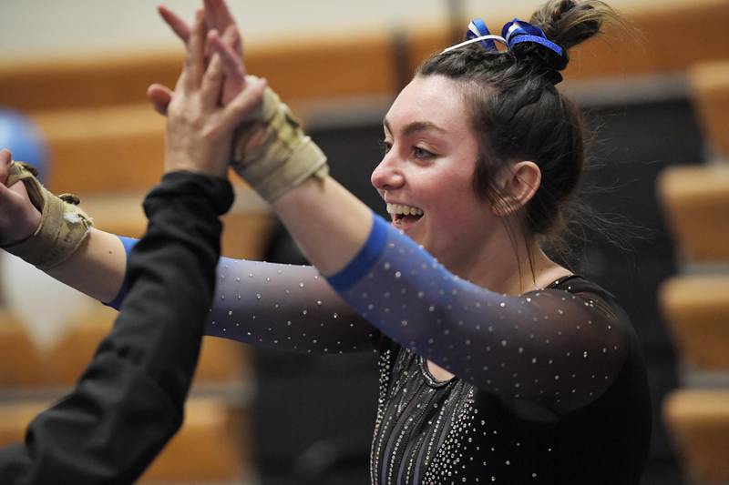 Geneva’s Sadie Karlson reacts after her vault at the Geneva girls gymnastics regional meet in Geneva on Wednesday, February 1, 2023.