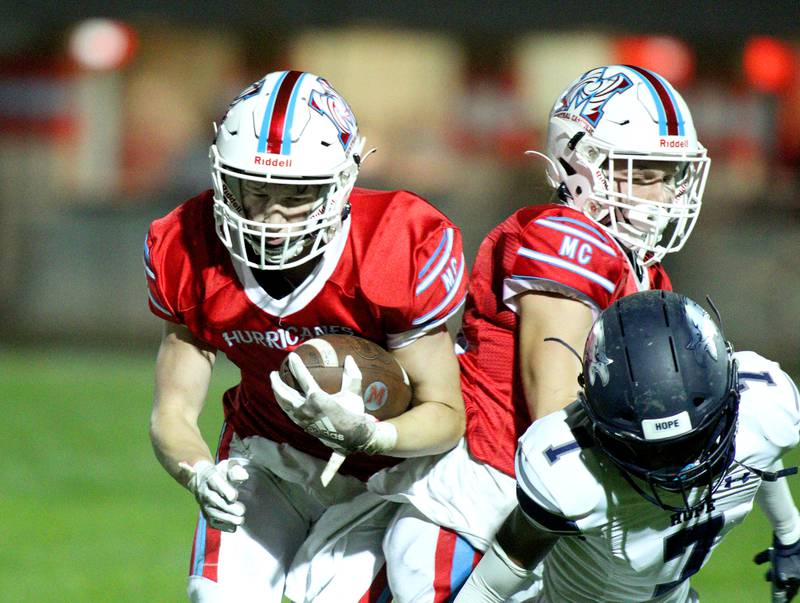 Marian Central’s Quinn Brady runs the ball against Chicago Hope in varsity football at Woodstock Friday night.