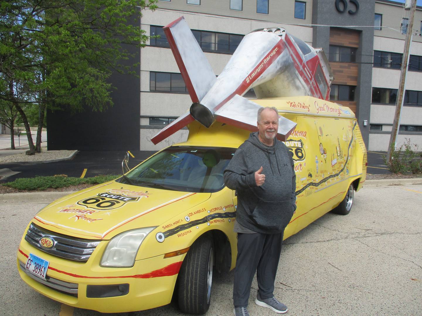Randy Alling of Channahon stands with what he calls a "Fusion van." comprised of sections from two Ford Fusions and other attachments with artwork marking it for Route 66, as he prepared to start the Red Carpet Festival tour on Saturday. May 3, 2025