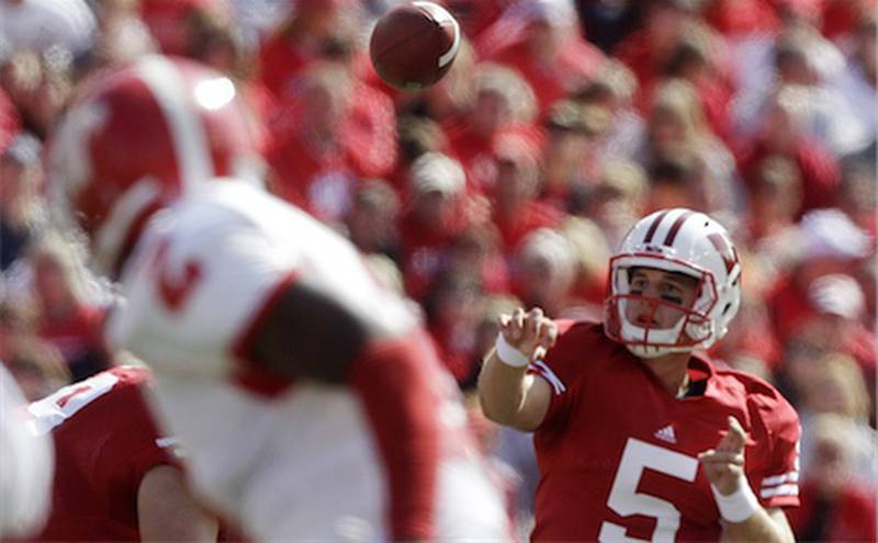 Wisconsin quarterback Jon Budmayr throws a pass Sept. 25, 2010, during the second half against Austin Peay in Madison, Wis. Budmayr will give up playing football after a series of injuries and will be a student assistant coach this season. (AP Photo/Morry Gash, File)