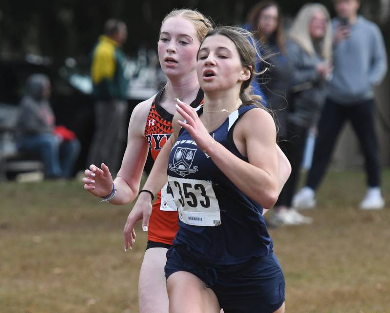 Byron's Ashley Potter and 
Rebecca Krein of Rockford (Our Lady of the Sacred Heart) sprint to the finish line of the 1A Winnebago Girls Regional on Saturday, Oct. 25, 2025 at the Levi and Ester Fuller Memorial Forest Preserve.