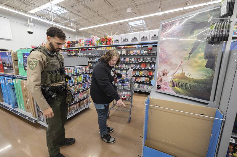 Lee County Deputy Josh Bailey-Smith shops with Hunter Saturday, Dec. 13, 2025, during the annual Shop with a Cop at Walmart in Dixon.
