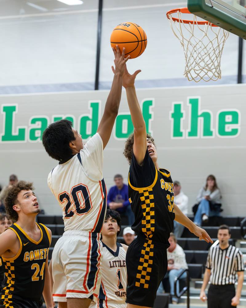 Nico Lopez (20) of DePue lays ball up whilst Vinny Bollino (32) of Reed-Custer jumps to contest shot during game in the Shipyard Showdown on Tuesday, December 23, 2025 at Seneca High School in Seneca.