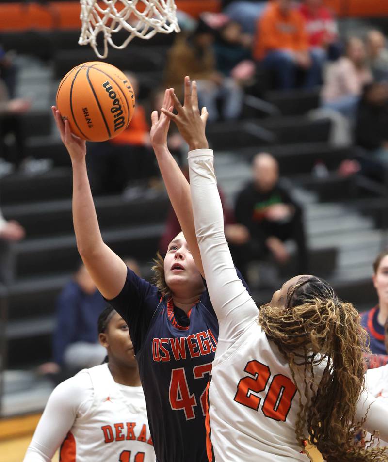 Oswego's Kendall Grant goes to the basket against DeKalb's Zora Watts during their game Monday, Jan. 5, 2026, at DeKalb High School.
