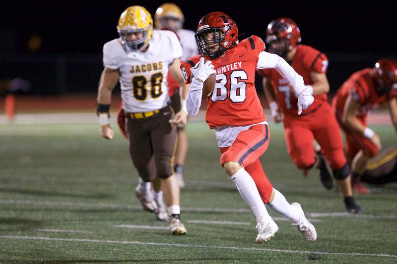 Huntley's Connor Ardell carries the ball for a gain against Jacobs on Friday, Sept. 23,2022 in Huntley.