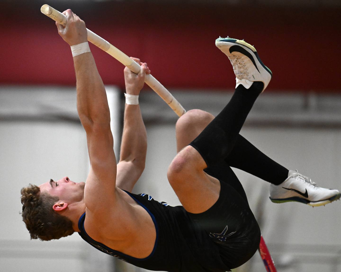 St. Charles North’s Nathan McLoughlin is about to clear the bar at 15-feet, six-inches while competing in pole vault during the DuKane Conference indoor track meet at Batavia High School on Friday, March 21, 2025.
