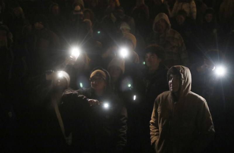 People sing along with the Woodstock Community Choir during the Lighting of the Square Friday, Nov. 29, 2024, in Woodstock. The annual holiday season event featured brass music, caroling, free doughnuts and cider, food trucks, festive selfie stations and shopping.