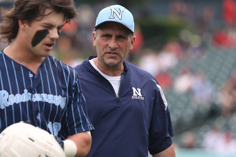 Nazareth head coach Lee Milano shares words with Lucas Smith as he heads to the dugout against Glenwood in the IHSA Class 3A State championship. Saturday, June 11, 2022 in Joliet.