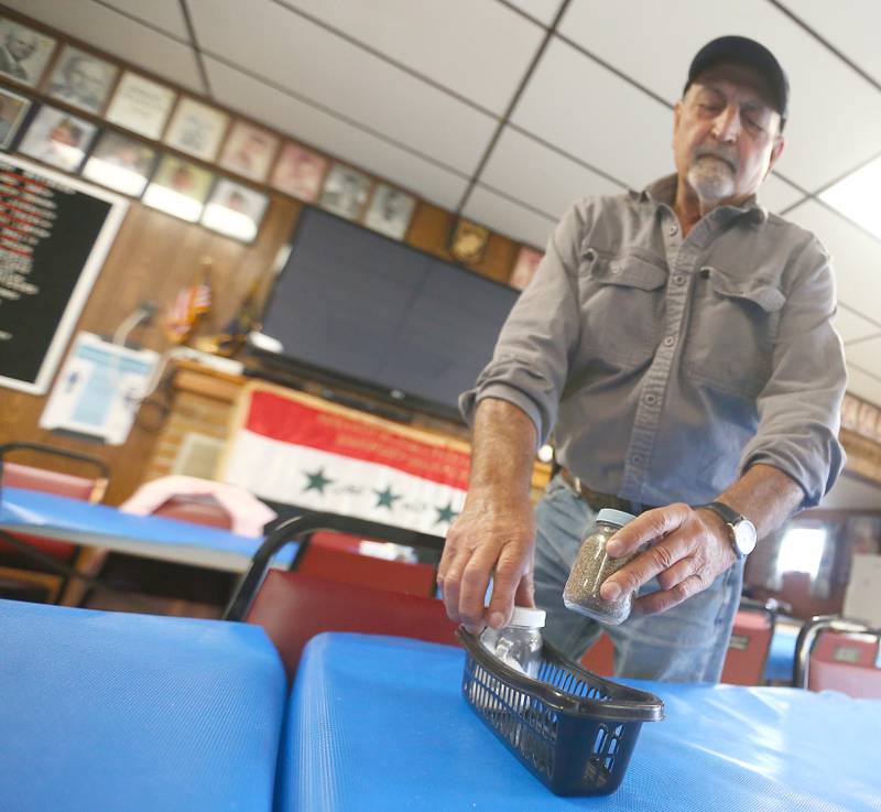 No more curbside pickup at the Oglesby American Legion: From now on it's dine-in or pickup at the counter. Greg Baker, commander of the American Legion hall in Oglesby, places salt and pepper shakers onto the tables in preparation of indoor dining starting July 2. The hall is re-opening its dining area to customers for their fundraisers including steak dinners, fish fries and tacos.