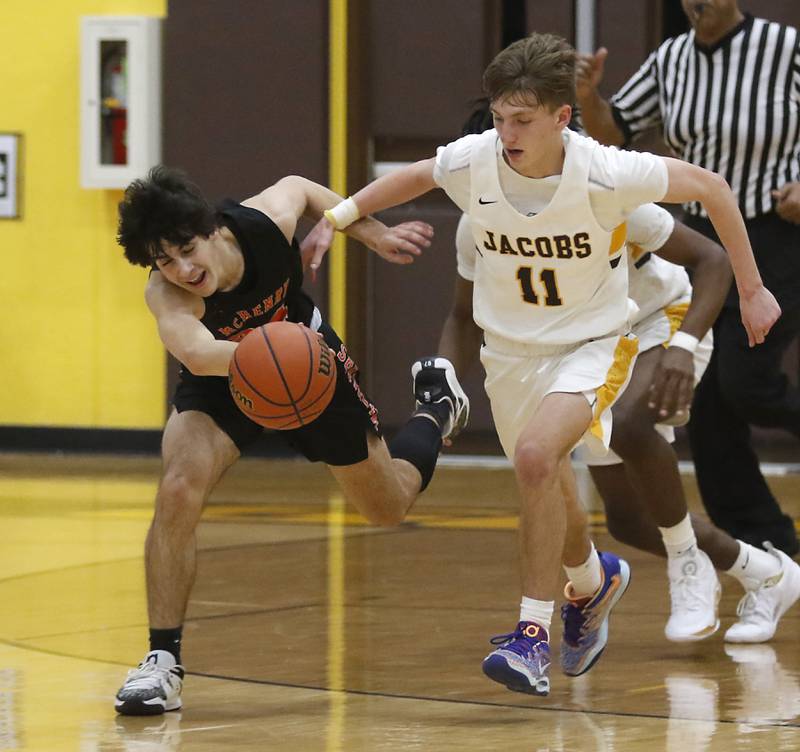 McHenry's Marko Visnjevac is fouled by Jacobs' Carter Roper during a Fox Valley Conference basketball game Wednesday, Dec. 7, 2022, between Jacobs and McHenry at Jacobs High School in Algonquin.