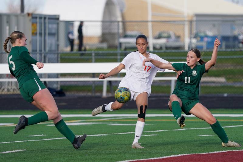Oswego’s Analia Ortiz (17) takes a shot on goal between Bartlett's Mia Lamz (5) and Karolina Boguslawski (11) during a soccer mach in the Plainfield Classic  at Plainfield North High School on Tuesday, April 15, 2025.