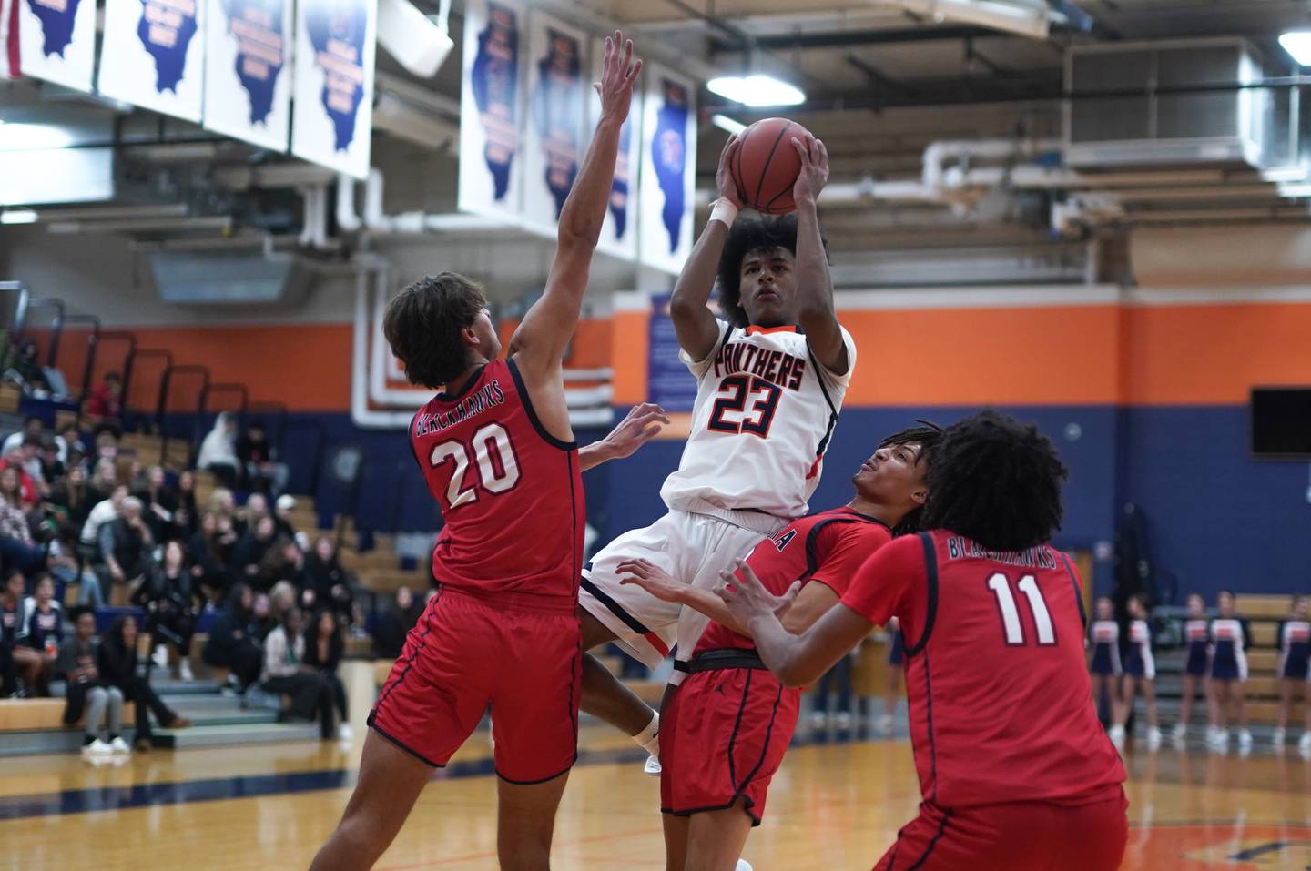 Oswego’s Dasean Patton (23) shoots the ball in the post against West Aurora's Billy Samp (20) and Terrence Smith (5) during a basketball game at Oswego High School on Friday, Dec 1, 2023.