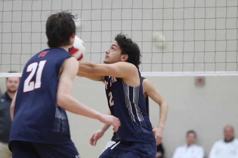St. Viator’s Mateo Masiclat keeps the volley alive against Joliet Catholic on Wednesday, April 24, 2024 in Joliet.