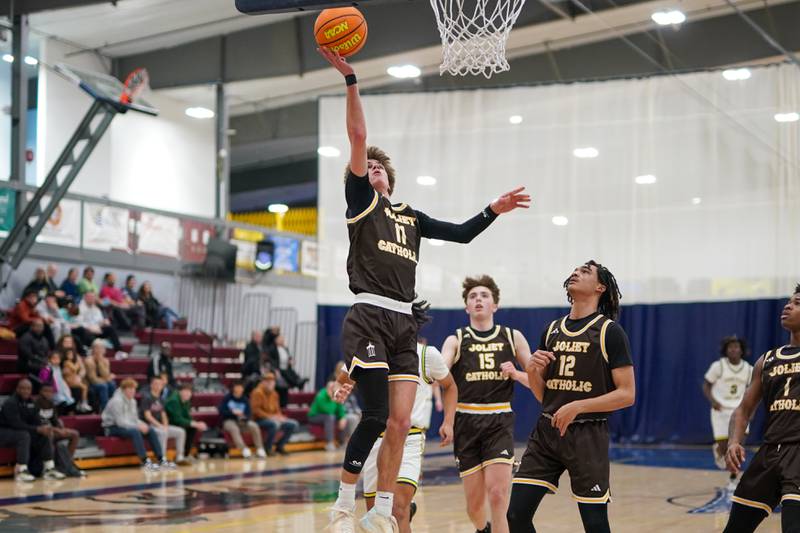 Joliet Catholic's Jack Superits (11) drives to the basket against Yorkville Christian's Jayden Riley (3) during a basketball game at Yorkville Christian High School on Monday, January 13, 2017.