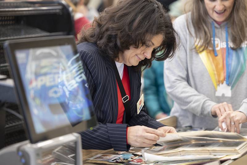 Jennifer LeFever looks through old photos put on display at Oliver’s Corner Market Saturday, April 4, 2026, in Dixon. LeFever worked at the store for 8 years, starting when it was called Jack and Jill.
