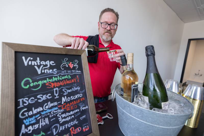 J.C. Heerdt of Vintage Wines pours a celebratory glass of wine at the opening of the Spring Valley Community Center on August 7, 2025 in Spring Valley.