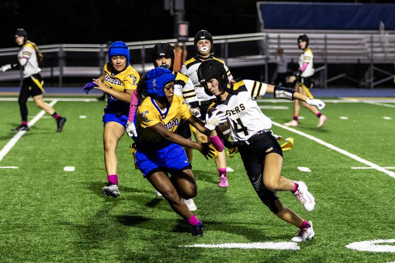 Joliet West's Ella Featherston dodges the Joliet Central defense during a varsity flag football game at Joliet Central on Oct. 2, 2025.