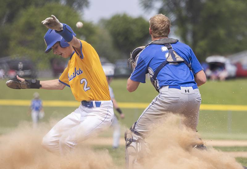 Johnsburg’s Riley Johnson slides in safe at home in front of Newman’s Daniel Kelly Saturday, May 31, 2025, in the Class 2A Sectional final in Mendota. Johnson was then called out for leaving early on the sacrifice.