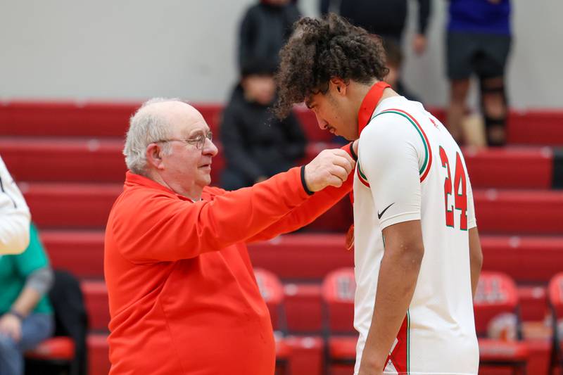 Frank Colmone puts “All Tournament” medal on Mario Persich of L-P on Saturday, December 14, 2024 at Hall High School in Spring Valley.