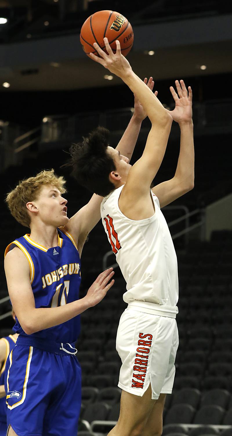 McHenry's Hayden Stone, right, drives to the basket agains Johnsburg's Ben Person during a non-conference basketball game Sunday, Nov. 27, 2022, between Johnsburg and McHenry at Fiserv Forum in Milwaukee.