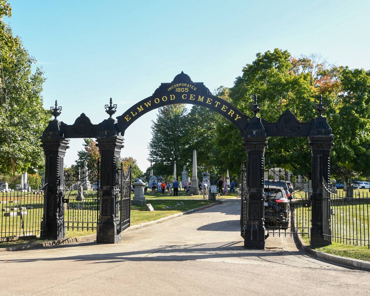 Community members listen to Harlan Hawkins talk about H.C. Whittemore during the Etched in Stone cemetery walk on Sunday Oct. 5, 2025, held at Elmwood cemetery in Sycamore.