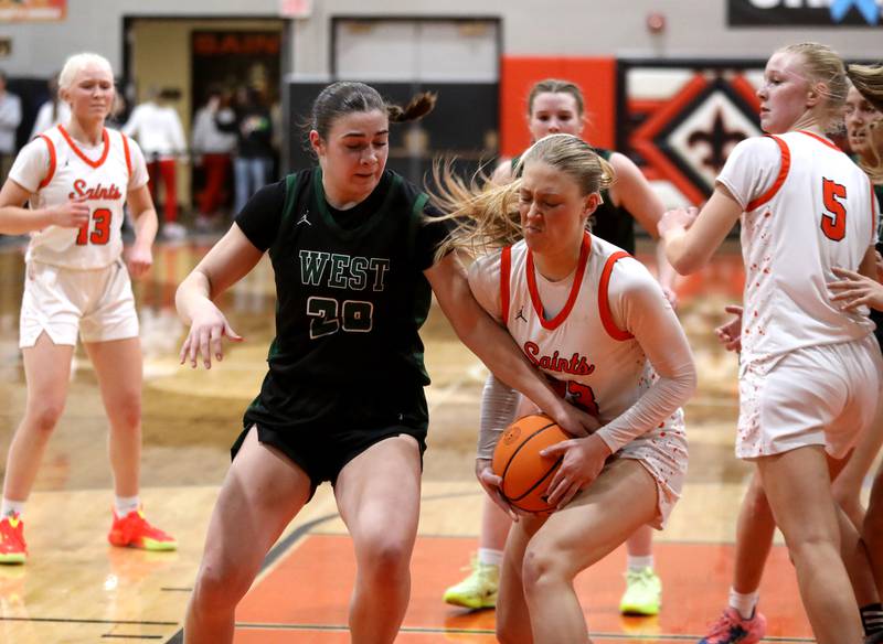 Glenbard West's Ellie Noble and St. Charles East's Alyse Price battle for possession during a Class 4A St. Charles East Sectional semifinal on Tuesday, Feb. 25, 2025 in St. Charles.