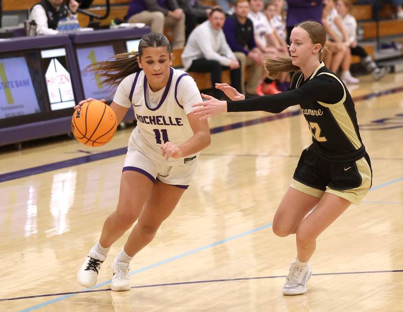 Rochelle's Audrina Rodriguez drives by Sycamore's Sadie Lang Friday, Dec. 5, 2025, during their game at Rochelle High School.