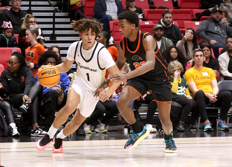 Sycamore's Josiah Mitchell goes baseline against DeKalb's Justin O’Neal during their game Friday, Jan. 31, 2025, in the FNBO Challenge in the Convocation Center at Northern Illinois University in DeKalb.