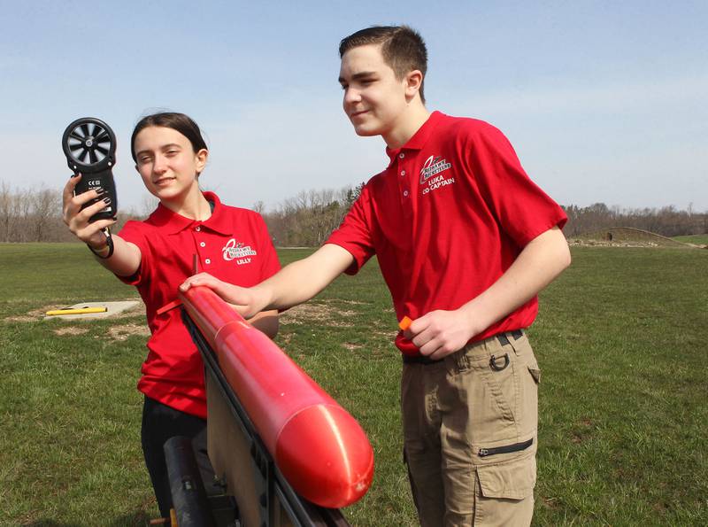 Lilly Abney, of Round Lake Beach and Luka Weideman, of Lindenhurst, both 14, with the Prince of Peace Redhawk Rocketeers TARC Team look at a anemometer to see the speed of wind as they get ready to test launch their rocket to compete in the upcoming American Rocketry Challenge at the Tim Osmond Sports Complex in Antioch. The finals are held next month in Washington, D.C. on May 14th.