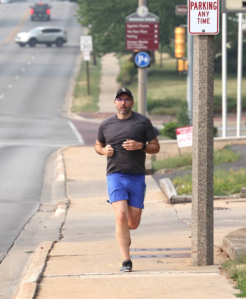 Shawn Beck, from DeKalb, runs south Wednesday, June 28, 2023, on First Street near Lincoln Highway in DeKalb. Beck recently completed his goal of running every street in DeKalb County.