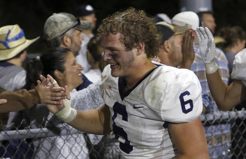 Cary-Grove's Charles Ciske “high five” the Cary-Grove fans after  a Fox Valley Conference football game on Friday, Sept. 27, 2024, at Prairie Ridge High School.