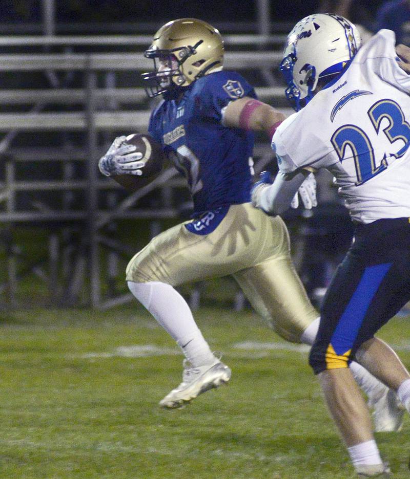 Marquette’s Grant Dose breaks away from the pack to score a touchdown against Aurora Central Christian in the 1st quarter Friday at Marquette.