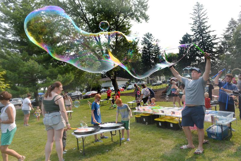 Eric Schlukebir, of German Valley, make a very long bubble at Jason Kollum's "Big Bubble Time' bubble event at Ben Miller Park during German Valley Days on Saturday, July 15, 2023.