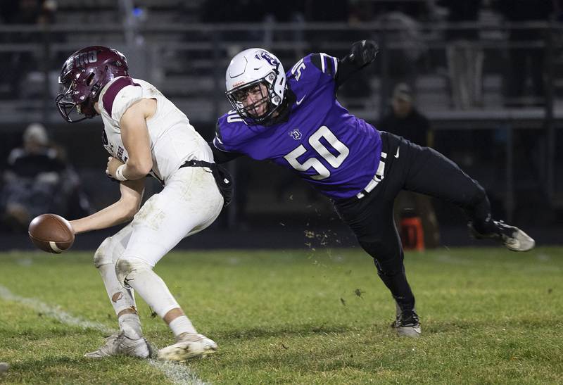 Dixon’s Aidan Howard looks to sack Marengo QB David Lopez Friday, Nov. 1, 2024 in the 4A football playoffs in Dixon.
