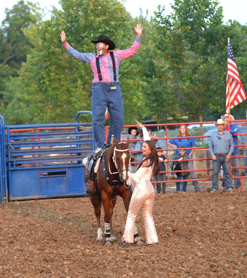 Rodeo clown Blake Potts and trick rider Saige McNeill perform during the T & A Bucking Bulls Rodeo at the Ogle County Fair on Friday, Aug. 1, 2025 in Oregon.