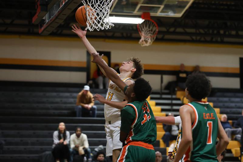 Joliet West’s Luke Grevengoed draws the foul on a layup against Plainfield East on Friday, Dec. 19, 2025 in Joliet.