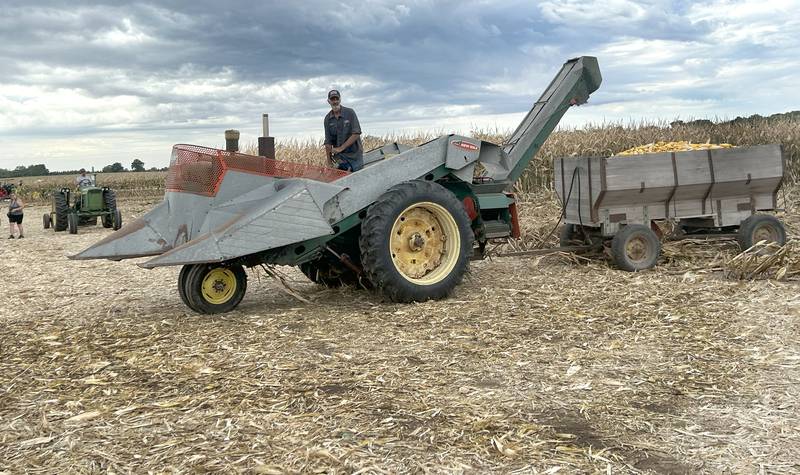 Kevin Bos, one of the owners of the Bos Bros. Historical Farm near Erie, drives his propane -powered 1966 John Deere tractor with its New Idea corn picking head to the corn crib during the farm's Old Fashioned Fall Harvest on Saturday, Sept. 21, 2024. Displays of antique ag equipment and hands-on demonstrations of past agricultural chores were highlighted at the event.