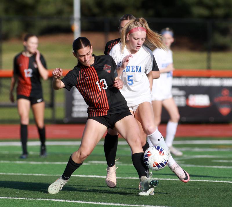 St. Charles East's Georggia Desario (left) and Geneva's Audrey Stredde go after the ball during the Class 3A St. Charles East Regional final on Friday, May 23, 2025 in St. Charles.