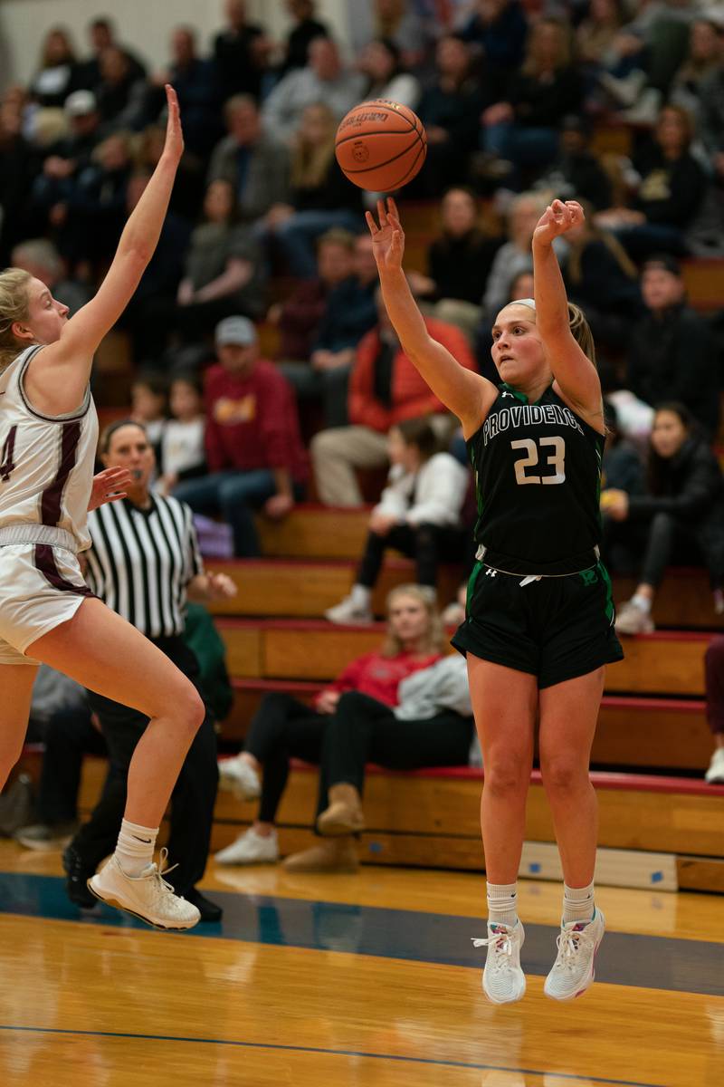 Providence's Annalise Pietrzyk (23) shoots a three-pointer against Montini’s Shannon Blacher (14) during the 3A Glenbard South Sectional basketball final at Glenbard South High School in Glen Ellyn on Thursday, Feb 23, 2023.