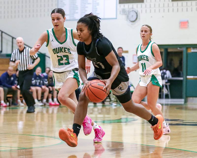 Oswego East's Desiree Merritt (21 drives down the lane )in their York Thanksgiving Tournament game between Oswego East at York on Monday, Nov 18, 2024  in Elmurst.