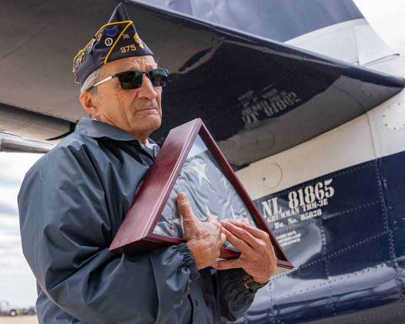 American Legion Honor Guard, Phil Valle brings a folded flag over to the TBM airplane for the memorial flight during the 10th annual TBM Avenger Reunion and Airshow on Saturday, May 17, 2025 at the Illinois Valley Regional Airport in Peru.