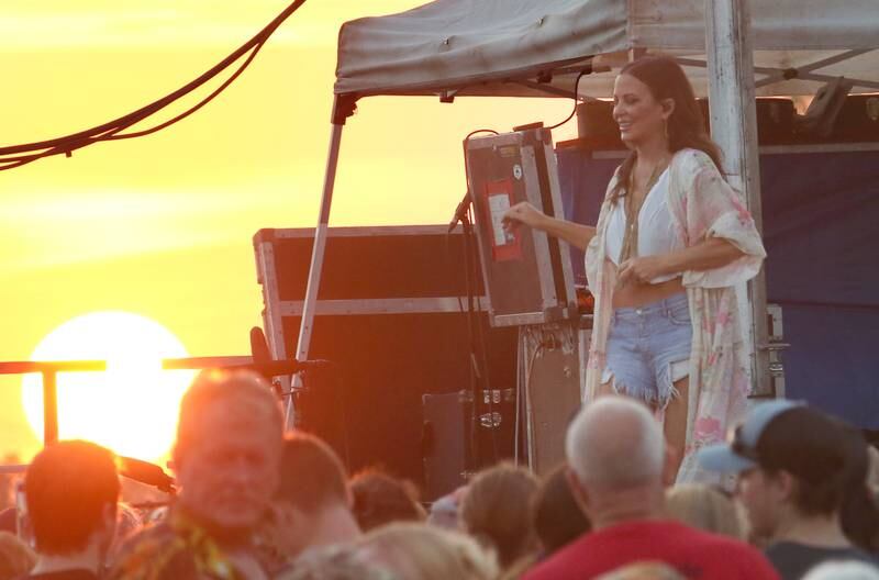 The sun sets behind Country Music star Sara Evans on Thursday, Aug. 24, 2023 at the Bureau County Fair in Princeton.