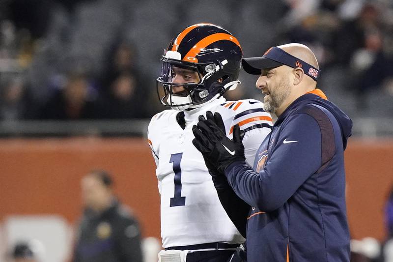 Chicago Bears quarterback Justin Fields listens to head coach Matt Nagy before a game against the Minnesota Vikings Monday, Dec. 20, 2021, in Chicago.