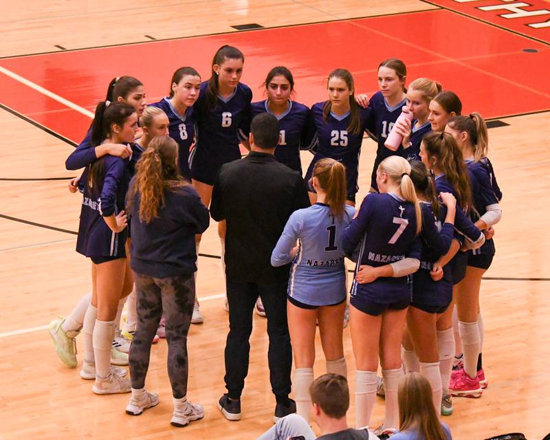 Nazareth Academy talk during a timeout on the court while taking on Geneva in the Sectional title game held at Timothy Christian High School.