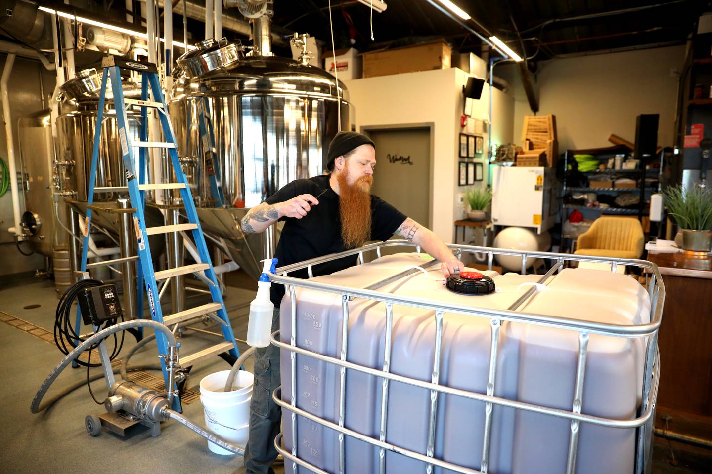 Obscurity cider and mead maker Zak Beckman hooks up apple juice at the Obscurity Mead Hall and Cidery in Elburn.