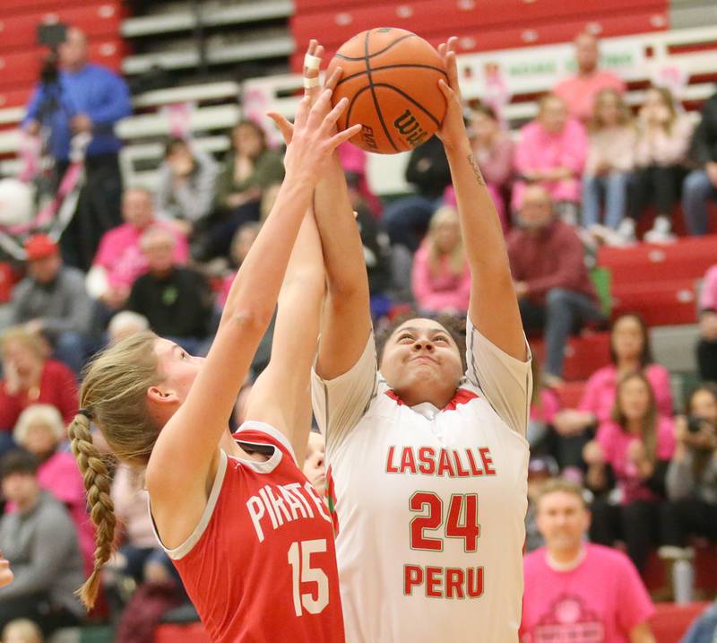 L-P's Jasmine Garman grabs a rebound over Ottawa's Hailey Larsen on Friday, Jan. 27, 2023 at L-P High School.