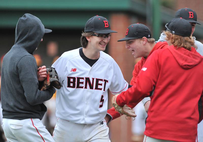 Benet relief pitcher K.J. Powers (5) celebrates with teammates after coming into the game and getting one important out to stop a Montini threat during a game on Apr. 28, 2022 at Benet Academy in Lisle.
