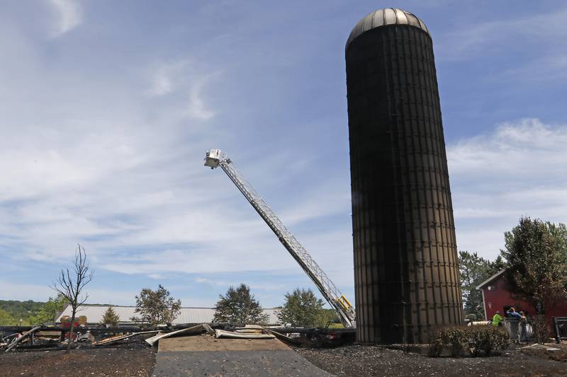 The remains of barn in the 1600 block of South Rose Farm near Woodstock, after a fire leveled the building on Monday, June 1, 2024.