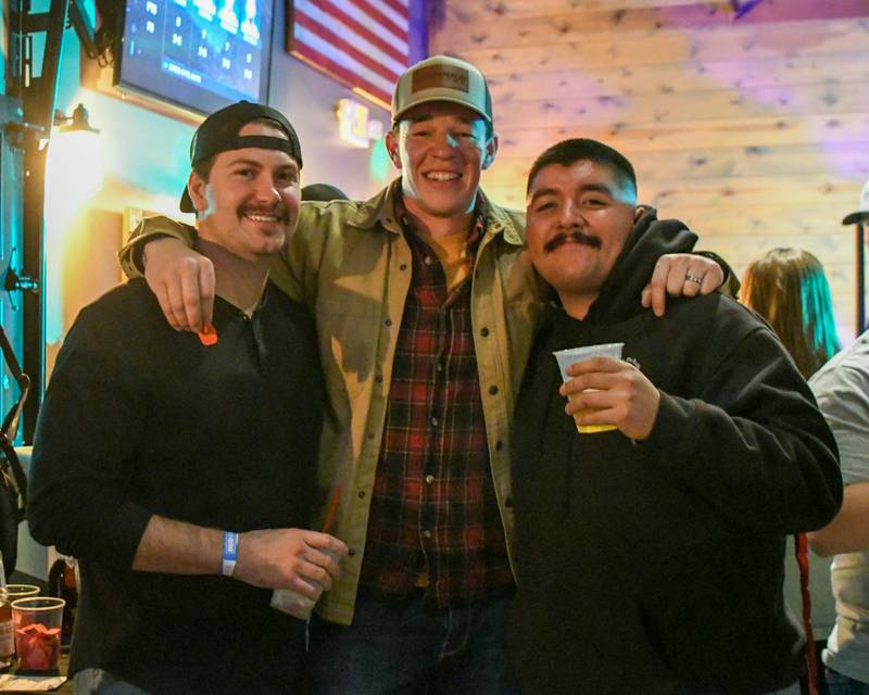(From left) DeKalb firefighters Austin Isham, Logan Wright and Juan Gasca pose for a photo on Wednesday, Nov. 27, 2024, at Fatty's Pub and Grille in DeKalb during the DeKalb Fire Fighters Local 1236 union's Tip A Firefighter event to fundraise for the Muscular Dystrophy Association.
